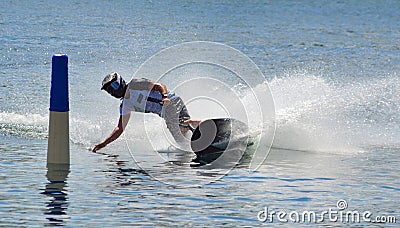 Motosurf Competitor taking corner at speed making a lot of spray. Stock Photo