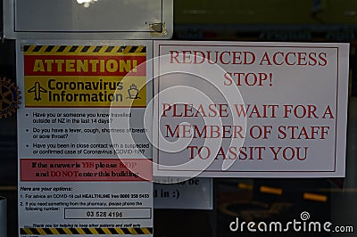 New Zealand, March 25 2020: Warning sign and instructions in shop window in response to Covid Editorial Stock Photo