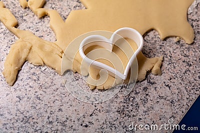 Moulds, hearts, flour and dough for Christmas biscuits Stock Photo