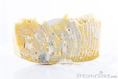 A mouldy cheddar cheese on a white background, close up, isolated Stock Photo