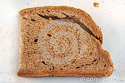 Mouldy moldy bread. Mould growing old bread on wooden table. Wastage of bread and stale bread Stock Photo