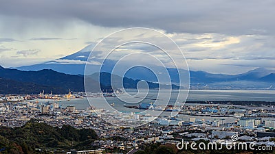 Mount Fuji and Shizuoka city with commercial cargo port foreground in the morning in japan, selective focus on fuji mountain Editorial Stock Photo