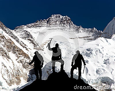 Mount Lhotse and silhouette of group of climbers Stock Photo