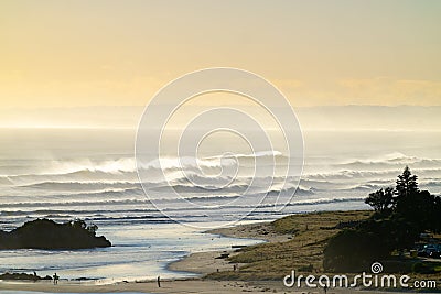 Mount maunganui main beach shrouded in sea haze caused by large surf from Cyclone Cody Stock Photo