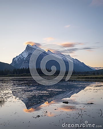 Mount Rundle reflected in Vermilion Lakes at sunrise. Banff. Canadian Rockies. Vertical format Stock Photo