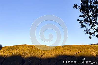 Mountain against a clear blue sky at sunset Stock Photo