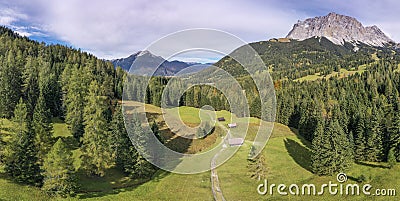 Mountain alps panorama and meadow with forest at zugspitze ehrwald Stock Photo