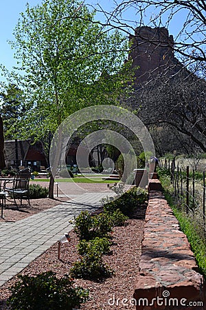 Stone wall and cement path leading to mountain Stock Photo