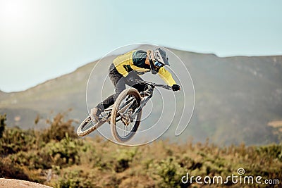 Mountain bike, man and action air jump and bicycle, challenge and adventure, freedom and fast race in nature. Cycling Stock Photo