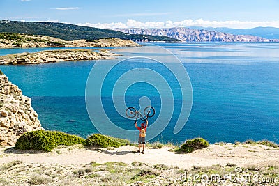 Mountain biker celebrating inspiring view at the sea Stock Photo