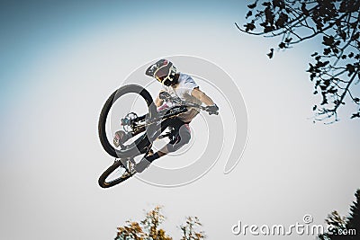 Mountain biker jumping over a dirt jump Stock Photo