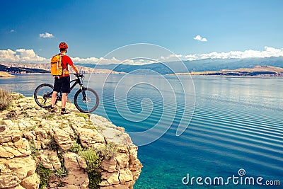 Mountain biker looking at view and riding a bike Stock Photo