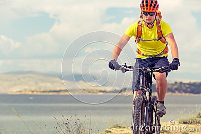 Mountain biker riding on bike at the sea Stock Photo