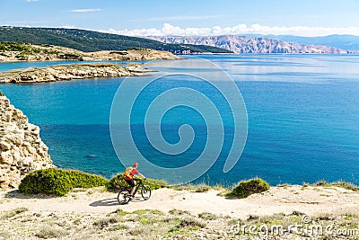 Mountain biker riding on bike in summer sunset woods Stock Photo