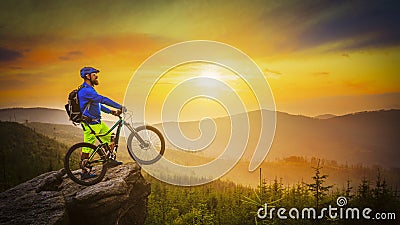 Mountain biker riding at sunset on bike in summer mountains fore Stock Photo