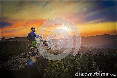 Mountain biker riding at sunset on bike in summer mountains fore Stock Photo