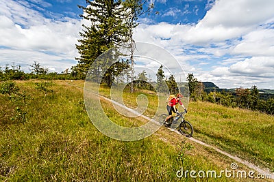 Mountain biking man riding in woods and mountains Stock Photo