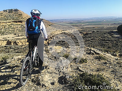 Mountain biking rider looking at desert Editorial Stock Photo