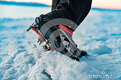 Mountain Boot with crampons on while hiking in the mountains in winter. Stock Photo
