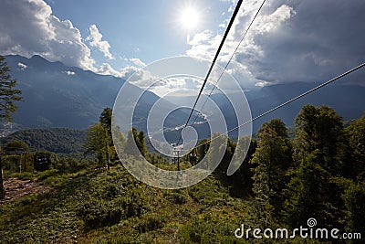 Mountain cableway stretching down over beautiful early autumn mountain landscape. Stock Photo