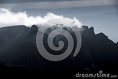 Mountain clouds at sunset, above high peaks Stock Photo