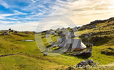 Mountain cottage on idyllic hill Velika Planina Stock Photo