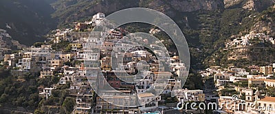 Mountain covered with houses and greenery Stock Photo