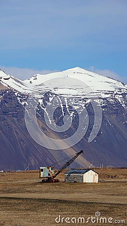 Mountain and crane near Hofn in east fjords in Iceland Stock Photo