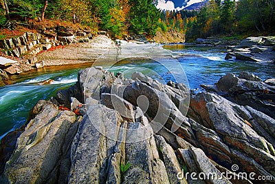 Mountain fast flowing river stream of water in the rocks at autumn Stock Photo