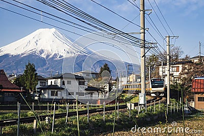 Mountain Fuji View landscape Village with local Train passing Japan Travel Editorial Stock Photo