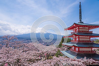 Mountain Fujiyama, a remarkable land mark of Japan in a cloudy day with cherry blossom or Sakura in the frame. The picture of Stock Photo