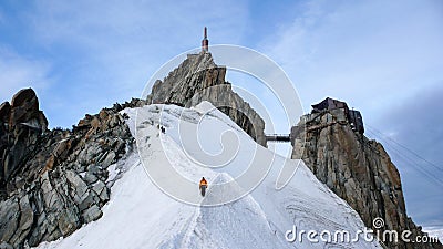 Mountain guide and a male client on a snow ridge heading down from a high summit in the French Alps near Chamonix Stock Photo