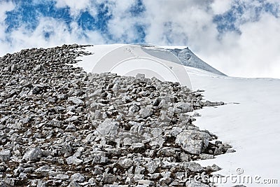 Mountain half snow half rocks Stock Photo