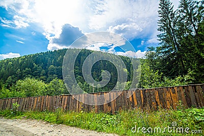 Mountain hills pure nature rural landscape. Fence from wooden logs Stock Photo