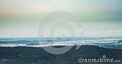 Mountain horizon coverd with cloud layers and forests Stock Photo