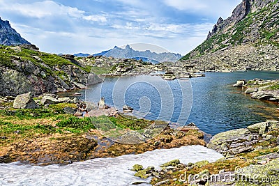 Mountain lake in hanging valley and melting snow Stock Photo