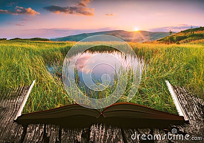 Mountain lake on the pages of an open book Stock Photo