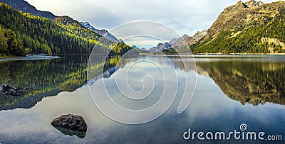 Mountain lake panorama with mountains reflection. Idyllic look. Autumn forest. Silvaplana Lake, Stock Photo