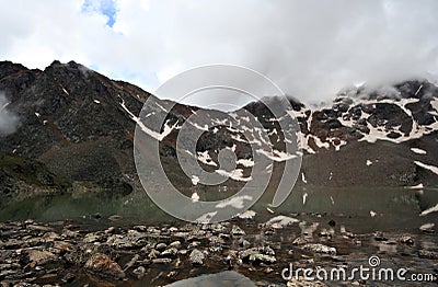 Mountain lake with reflection. Stones,haze,rocks. Stock Photo