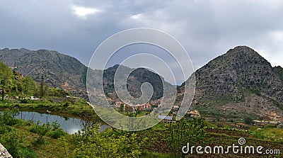 Mountain landscape in altitude in Lebanon green meadow and desertic summit Stock Photo