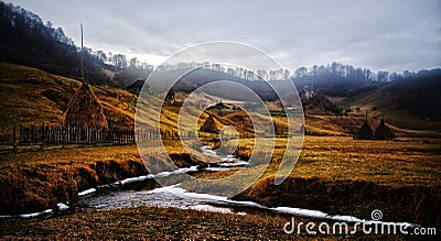 mountain landscape with autumn morning fog at sunrise - Fundatura Ponorului, Romania Stock Photo