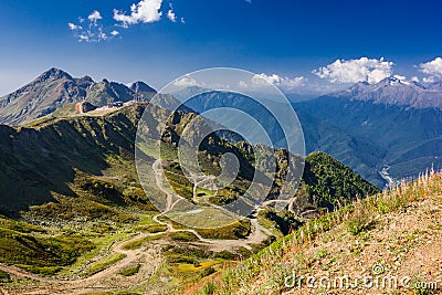 Mountain landscape clear day with rocks, serpentine road, blue sky Stock Photo
