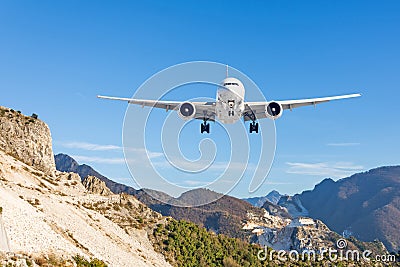 Mountain landscape and landing passenger aircraft. Travel to the mountainous countries Stock Photo