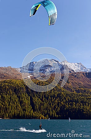 Mountain landscape with a lot of kite surfers and windsurfers moving in a lake Editorial Stock Photo