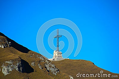 Mountain landscape with metallic cross and a blue sky Stock Photo