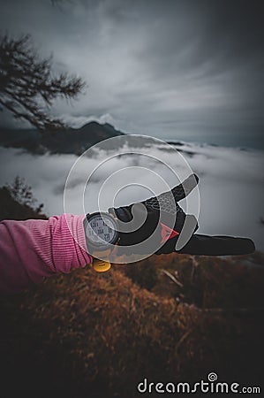 Mountain landscape. Misty forest. Portrait gilr enjoying run in the mountain. Watch detail Stock Photo