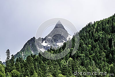 Mountain landscape - mountains forest, rocks glaciers snow clouds, Dombay, Karachay-Cherkessia, Russia Stock Photo