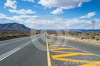 Mountain Landscape with a Person Crossing the Highway Stock Photo