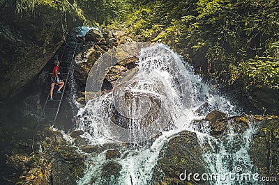 Mountain landscape in Slovakia. Magical forest in natural park .People climbing on steep rock on via ferrata martinske hole Editorial Stock Photo