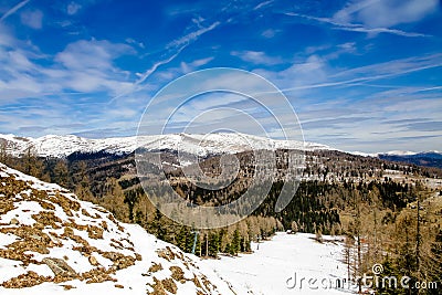 Mountain landscape with spruce and pine trees and ground covered by snow in a ski area in the Austrian Alps Stock Photo